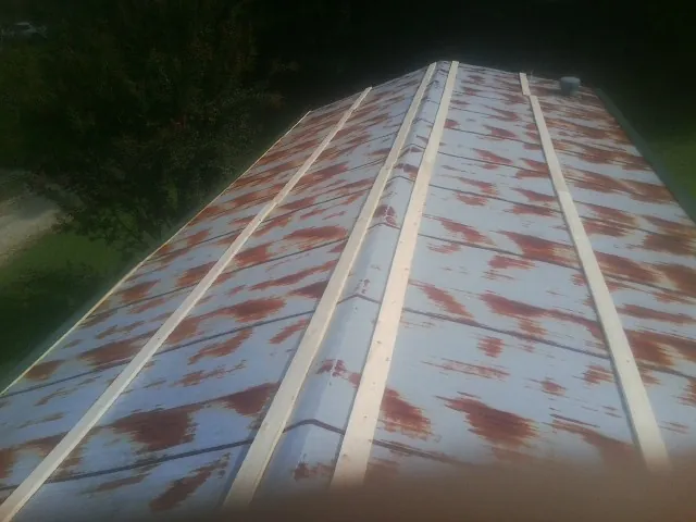Rusted metal roof panels with new wood purlins before replacement — Storm Damage Roof Repair in Fishing Creek by Roofing Brothers